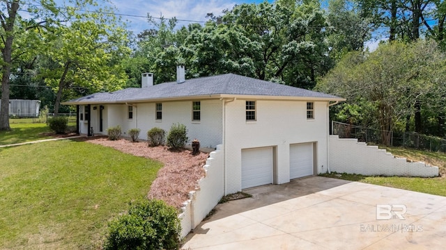 view of front of property featuring a garage, a front lawn, a chimney, brick siding, and driveway