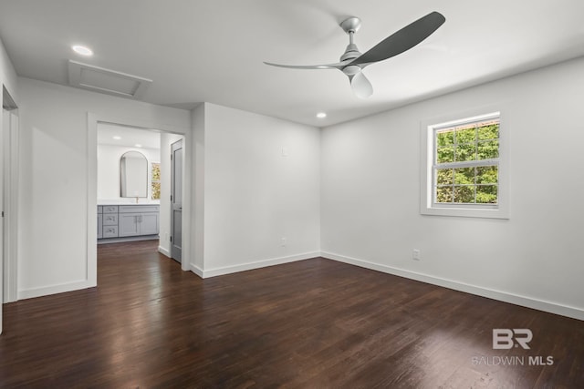 unfurnished bedroom with baseboards, attic access, dark wood-style flooring, and recessed lighting