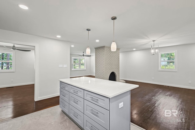 kitchen featuring plenty of natural light, light countertops, gray cabinets, and ceiling fan