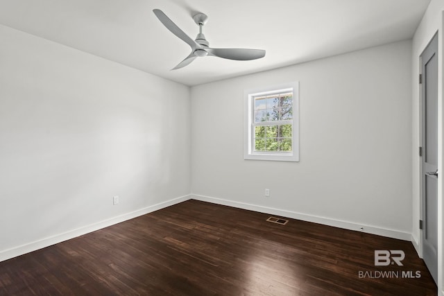 interior space featuring baseboards, ceiling fan, dark wood finished floors, and visible vents