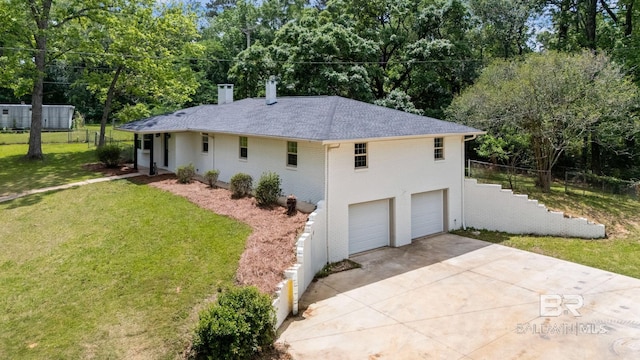 view of side of home featuring a chimney, a lawn, brick siding, concrete driveway, and an attached garage