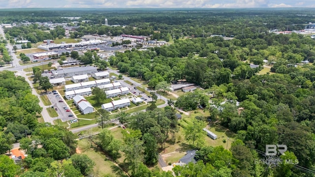 drone / aerial view with a wooded view