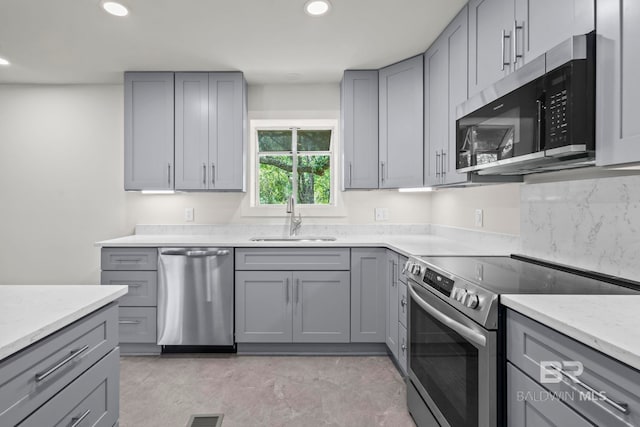 kitchen featuring a sink, gray cabinets, stainless steel appliances, and recessed lighting