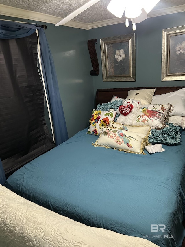 bedroom with a textured ceiling and crown molding