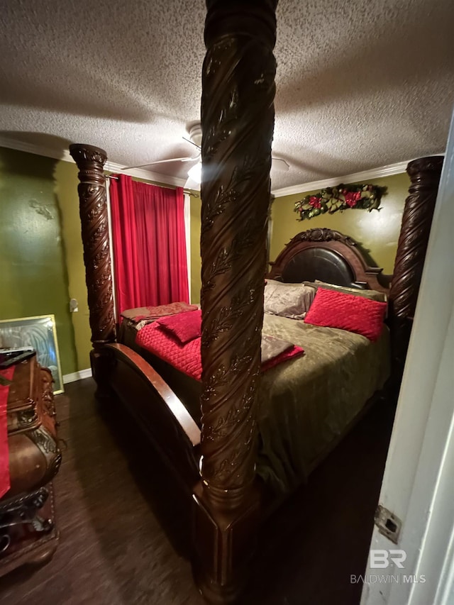 bedroom with a textured ceiling, wood finished floors, baseboards, ornamental molding, and ceiling fan