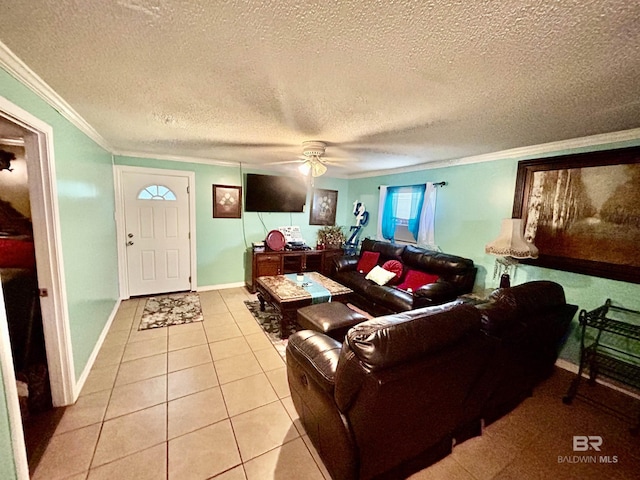 tiled living area with ornamental molding, a ceiling fan, a textured ceiling, and baseboards