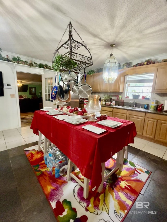 dining area featuring light tile patterned floors, a textured ceiling, and a chandelier