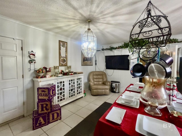 dining space featuring tile patterned flooring, crown molding, and a chandelier