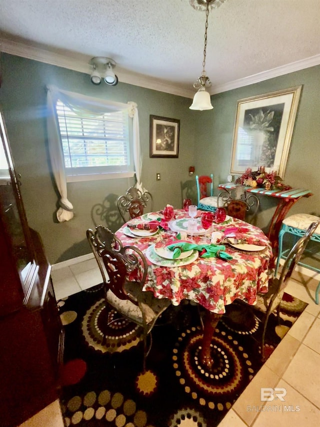 tiled dining space with ornamental molding and a textured ceiling
