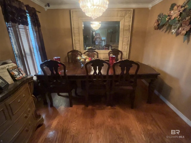 dining area with a chandelier, baseboards, ornamental molding, and wood finished floors