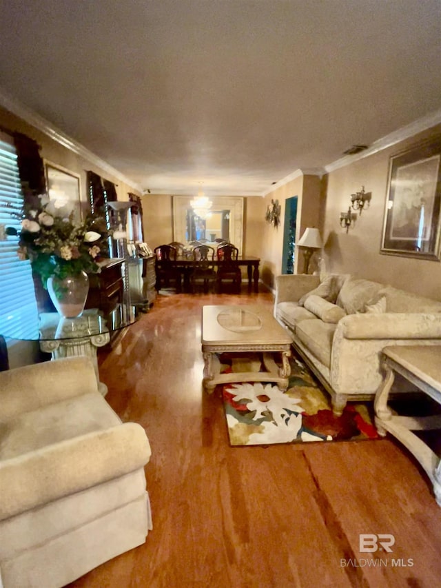 living room with crown molding and wood finished floors