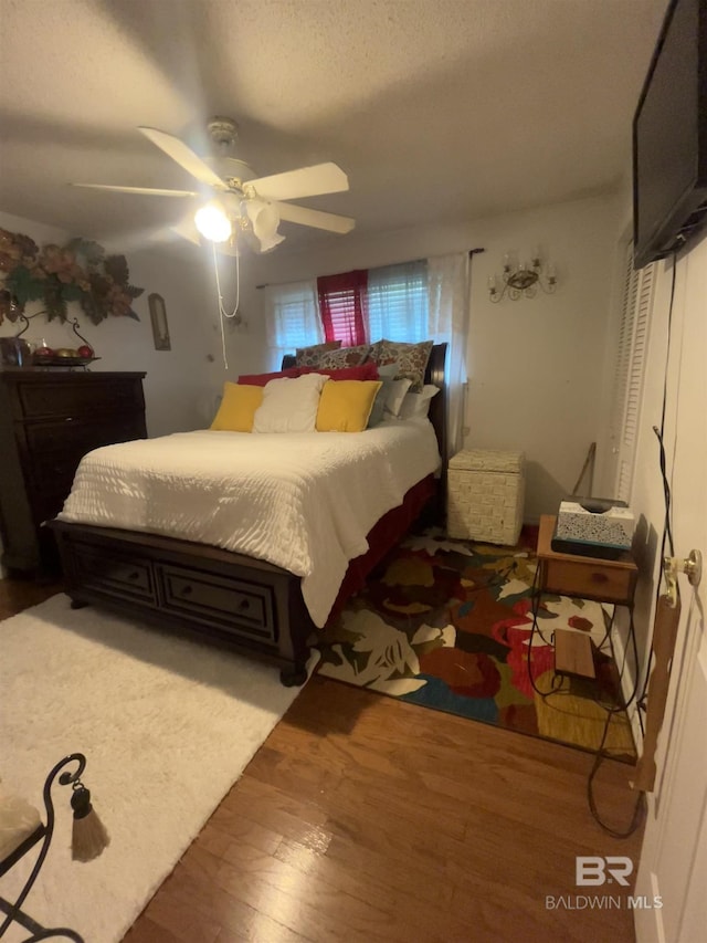 bedroom with wood finished floors and a ceiling fan