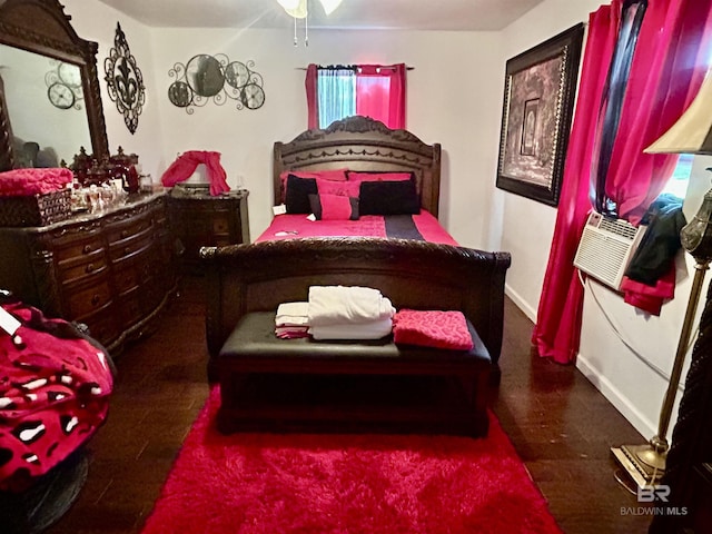 bedroom featuring wood finished floors, baseboards, cooling unit, and multiple windows