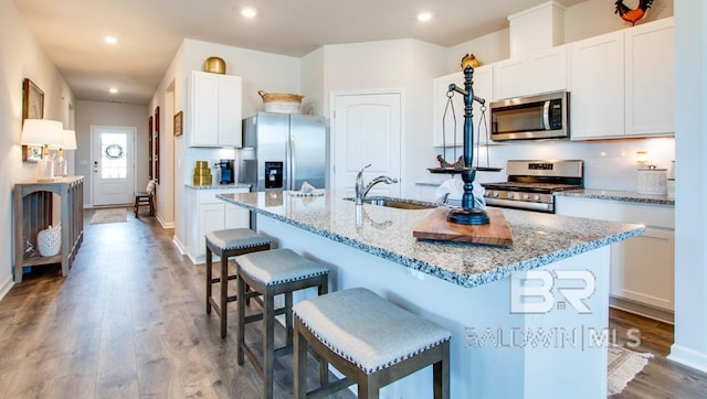 138 Preston Way, Gulf Shores, AL 36542 - kitchen featuring stainless steel appliances, a sink, a kitchen breakfast bar, backsplash, and a kitchen island with sink