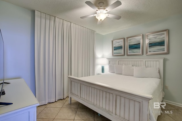 bedroom featuring light tile patterned floors, a textured ceiling, and ceiling fan