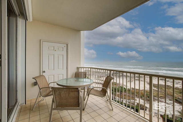 balcony with a water view and a beach view