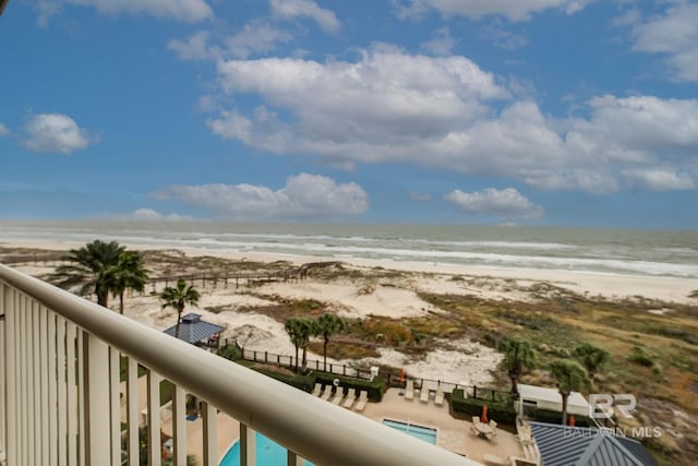 balcony featuring a water view and a beach view