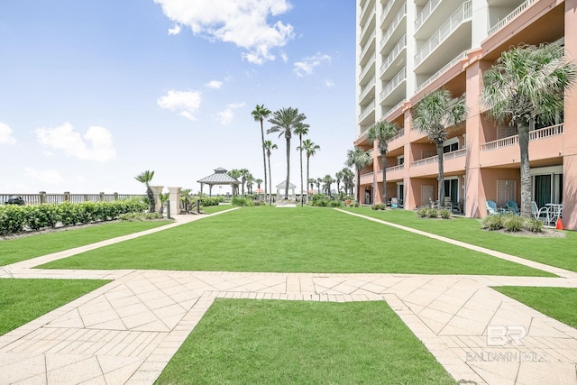 view of home's community with a lawn and a gazebo