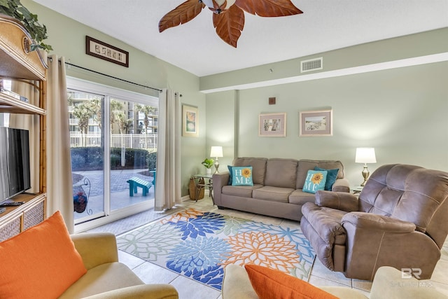 living area featuring visible vents and ceiling fan