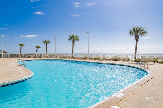 community pool featuring fence and a patio