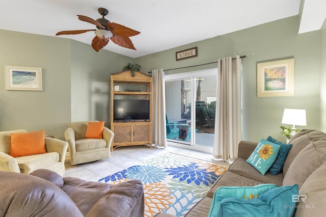 living room with a ceiling fan and tile patterned floors