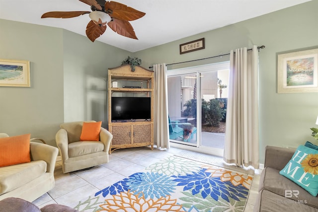 living area featuring ceiling fan and tile patterned floors