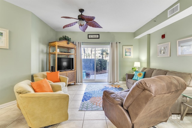 living area featuring ceiling fan, visible vents, baseboards, and light tile patterned flooring