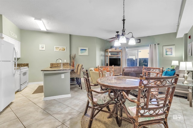 dining area featuring light tile patterned flooring and baseboards