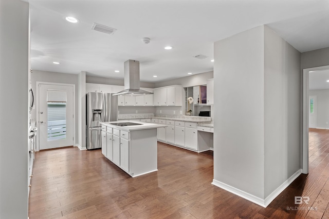 kitchen featuring hardwood / wood-style floors, range hood, stainless steel fridge with ice dispenser, a center island, and white cabinetry