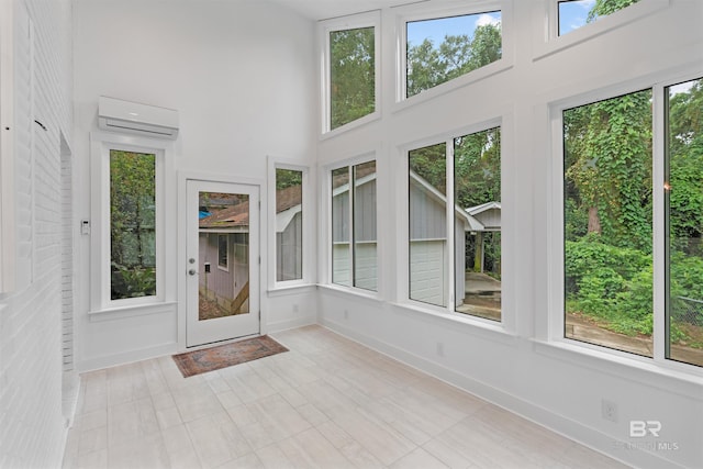 unfurnished sunroom with a wall mounted air conditioner