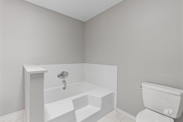 bathroom featuring toilet, a bath, and tile patterned flooring