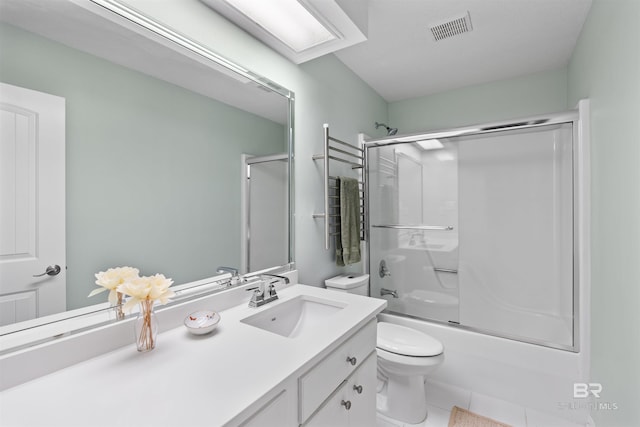 full bathroom featuring combined bath / shower with glass door, vanity, toilet, and tile patterned floors