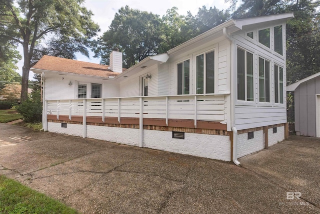 view of home's exterior featuring a sunroom