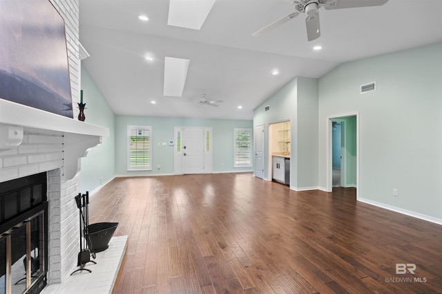 unfurnished living room with high vaulted ceiling, hardwood / wood-style floors, ceiling fan, and a brick fireplace