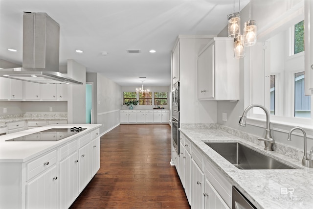 kitchen with an inviting chandelier, dark hardwood / wood-style flooring, island exhaust hood, sink, and white cabinetry