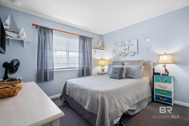 bedroom featuring a textured ceiling and carpet floors