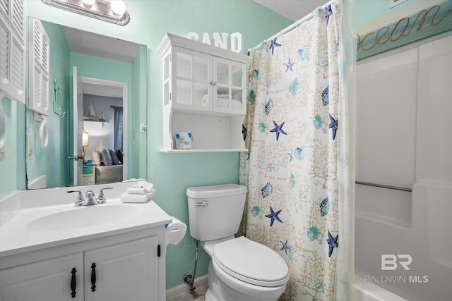 full bathroom with vanity, shower / bath combo with shower curtain, and toilet