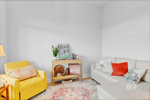 living area featuring baseboards and wood finished floors