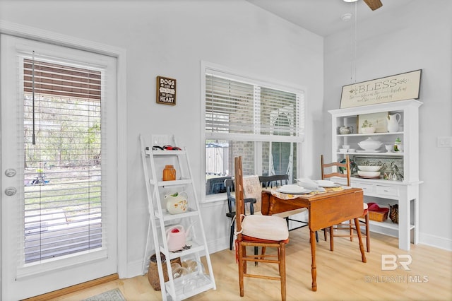 dining room with baseboards, ceiling fan, and light wood-style floors
