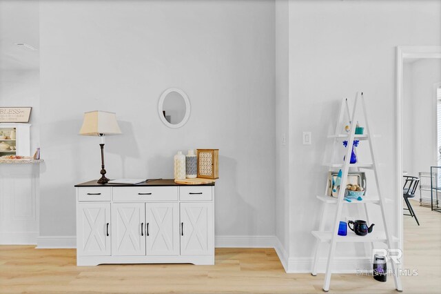 interior details with baseboards and wood finished floors