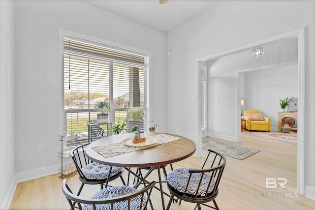 dining area with baseboards and wood finished floors