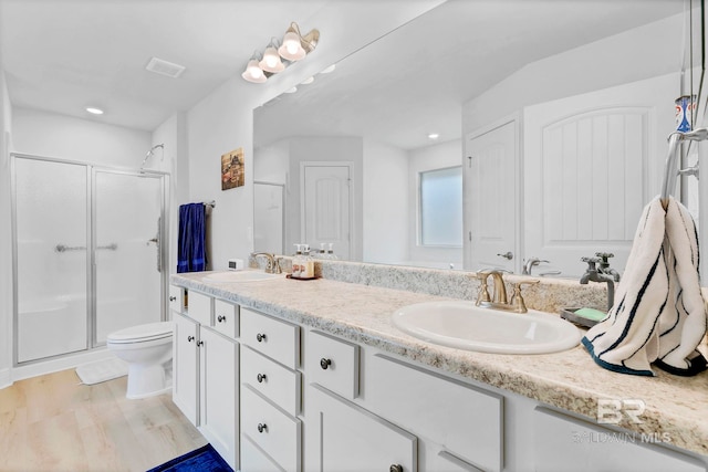 full bath featuring visible vents, a sink, double vanity, and a shower stall