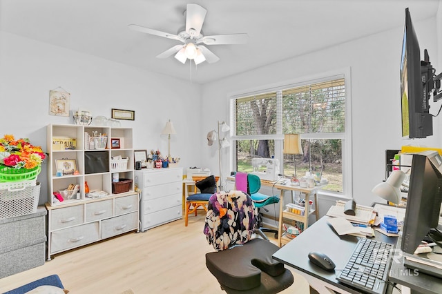 home office with wood finished floors, a ceiling fan, and plenty of natural light