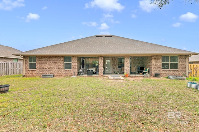 back of house with a yard, brick siding, fence, and a patio