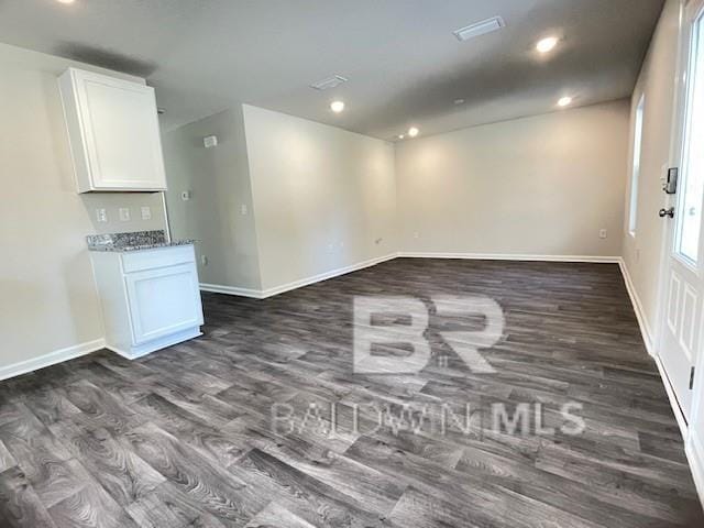 unfurnished room with dark hardwood / wood-style floors