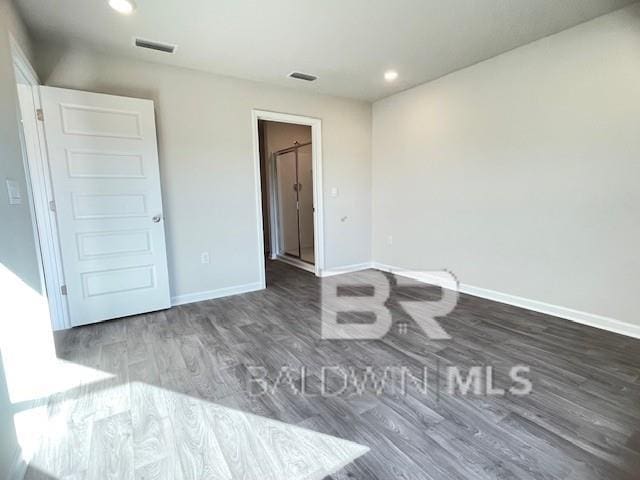 unfurnished bedroom with dark wood-type flooring