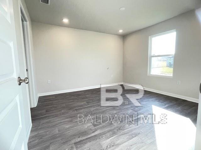 unfurnished room with dark hardwood / wood-style floors