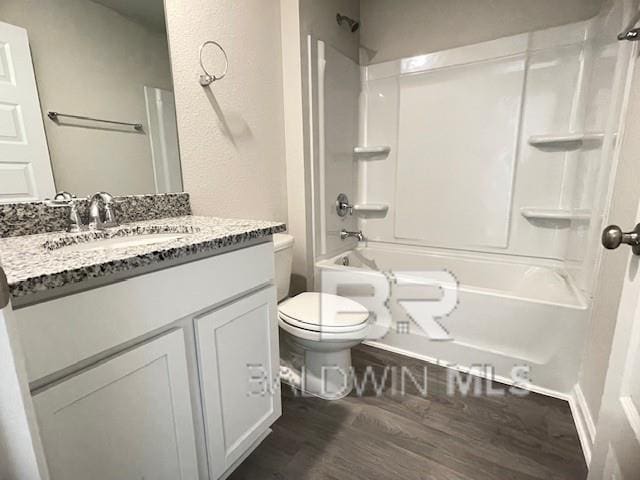 full bathroom featuring toilet, bathtub / shower combination, vanity, and hardwood / wood-style floors