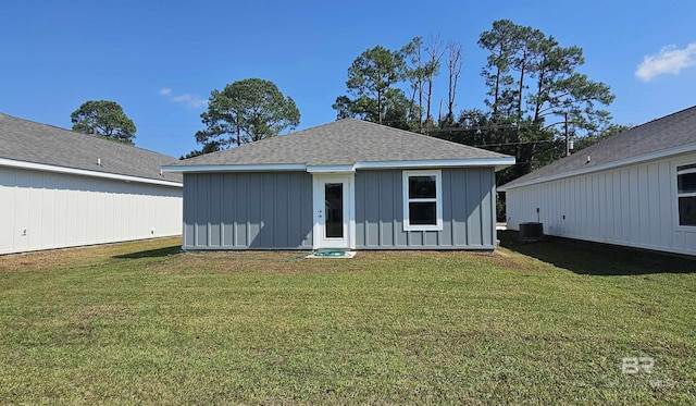 rear view of property featuring a lawn