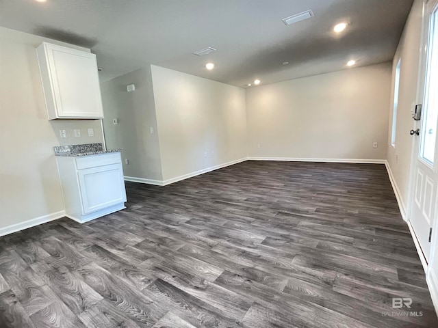 empty room with dark hardwood / wood-style flooring